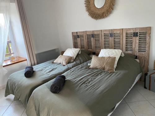 two beds sitting next to each other in a bedroom at Gîte du Trefoux logement Le Perche in Villaines-la-Gonais