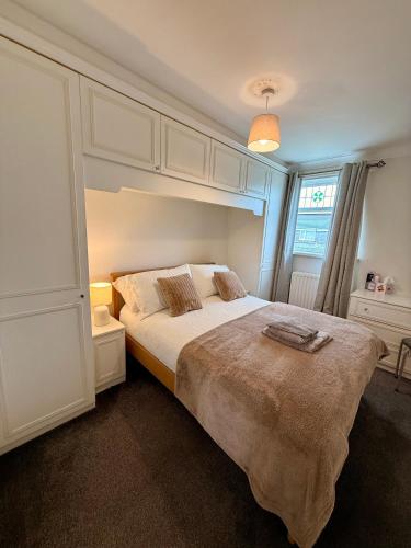 a bedroom with a large bed and a window at Ellington Escape in Ellington