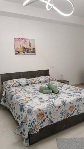 a bedroom with a bed with a comforter on it at Sabotino suite in Avezzano