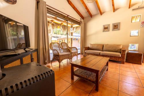 a living room with a couch and a table at Cabañas Refugio El Molle in El Molle