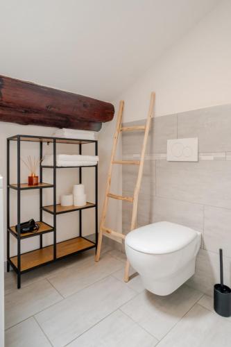 a bathroom with a white toilet and a shelf at Lake View - Gardone Center - Private Garage in Gardone Riviera