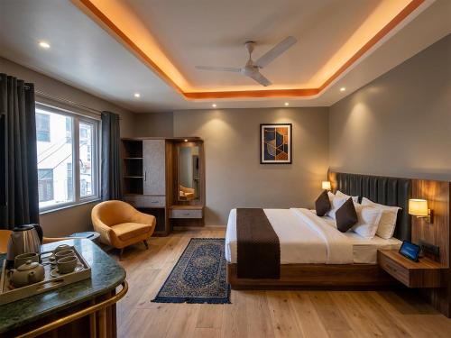 a hotel room with a bed and a kitchen at V Hotel Dev Residency Airport Pick up complimentary in New Delhi