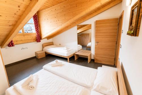 a bedroom with two beds in a attic at Appartamento Rio Duron by AMA Val di Fassa in Campitello di Fassa