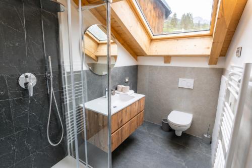 a bathroom with a shower and a sink and a toilet at Appartamento Rio Duron by AMA Val di Fassa in Campitello di Fassa