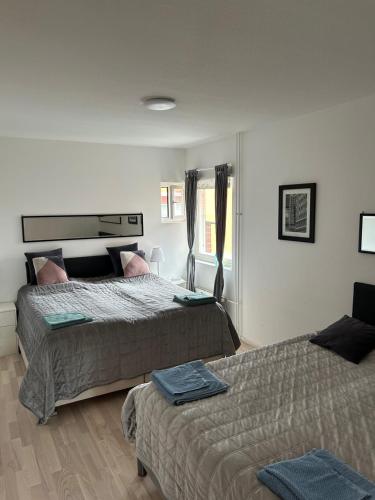 a bedroom with two beds and a window at Happy house katajanokka in Helsinki