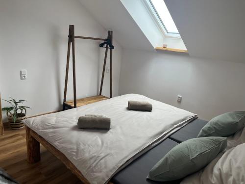 a bed with two pillows on it in a room at Upekla in Přibyslav