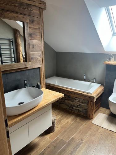 a bathroom with a sink and a bath tub at Upekla in Přibyslav