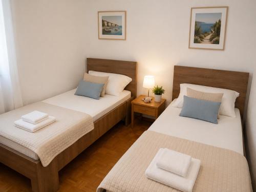 two beds in a small room with two pillows at Inter-nautika doo in Jezera