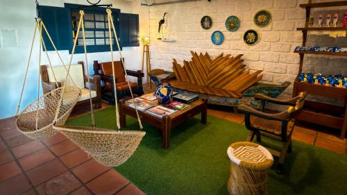 a living room with a hammock and a table and chairs at Praia Mole Hotel in Florianópolis