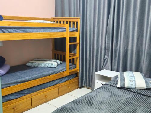 a bedroom with two bunk beds and a curtain at Apart ZSS in Penha