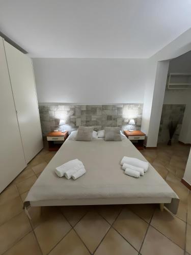 a bedroom with a bed with two towels on it at Residence Orizzonti app n 3 in Golfo Aranci
