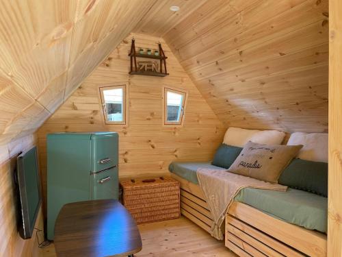 a cabin with a bed and a tv in it at Cabane Forest in Villaines-la-Gonais