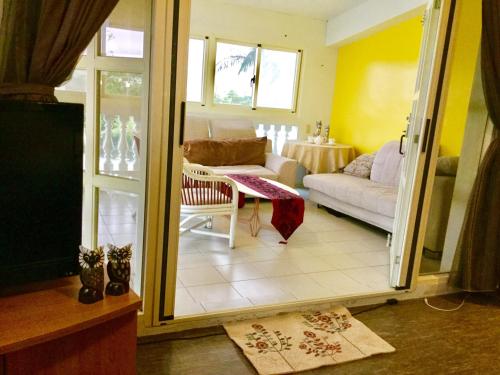 a living room with a couch and a table at Sunny Villa Homestay in Wujie