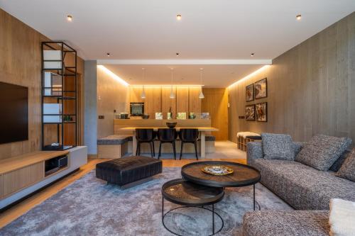a living room with a couch and a table at Isard Penthouse & Spa in El Tarter