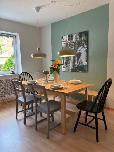 a dining room with a wooden table and chairs at Hotel Am Mühlenteich in Lübeck