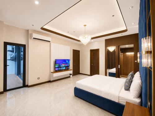 a bedroom with a bed and a flat screen tv at High Class 1BR at One Euphoria in Angeles