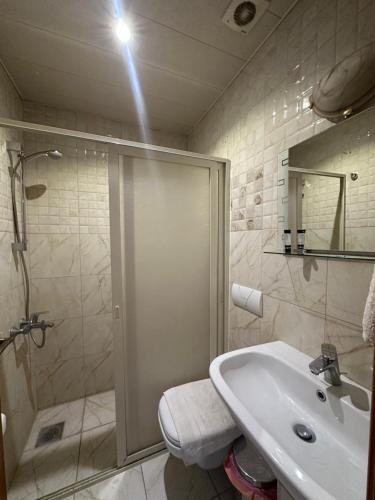 a bathroom with a shower and a sink at Hotel St Jean in Zahlé