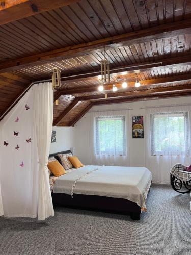 a bedroom with a large bed with butterflies on it at Ravne Konak in Visoko