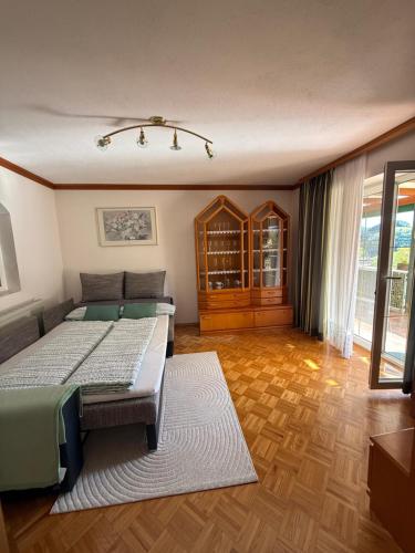 a bedroom with two beds and a large window at Wohnung im Grünen in Sankt Andrä