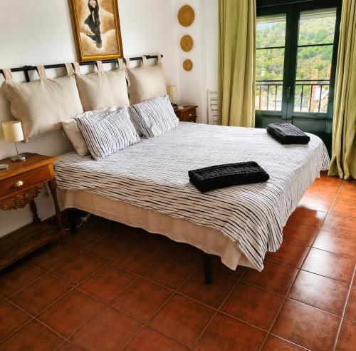 a bedroom with a bed with two pillows on it at La vista encantada in Frigiliana