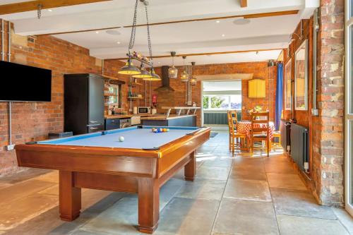a kitchen with a pool table in a room at Luxury Escape with Cinema, Pool Table & Darts in Leeds