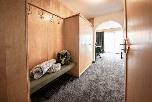 a hallway with a bench with pillows on it at Garni Rustica in Sölden