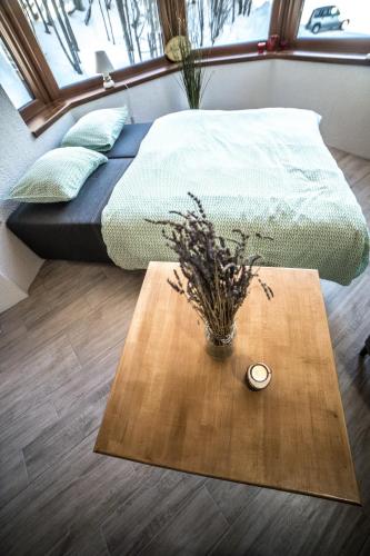 a bedroom with a bed and a table with a candle at Apartmán Chopok Juh Romantika 14 in Tale