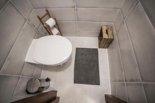 a bathroom with a white toilet in a room at Apartmán Chopok Juh Romantika 14 in Tale
