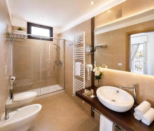 a large bathroom with a sink and a shower at HOTEL TRIESTE in Riccione
