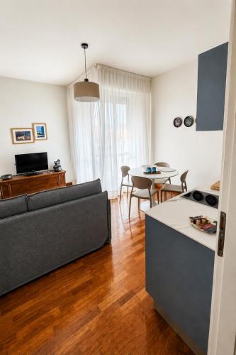 a living room with a couch and a table at Verde Acqua two Apartments in Lecco