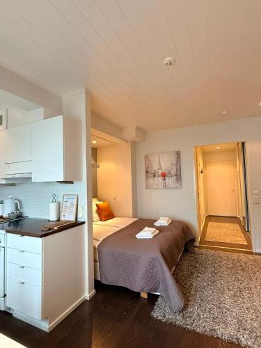 a small bedroom with a bed and a kitchen at KODA Walk Everywhere in Rovaniemi