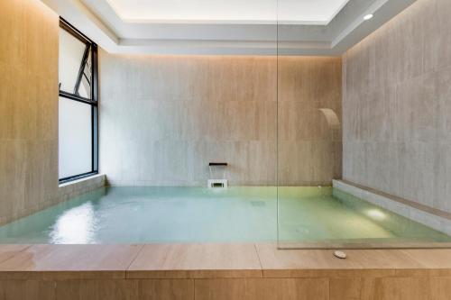 a large pool of water in a room with a window at Luxury 2 bedroom pool access apartment in Bang Tao Beach