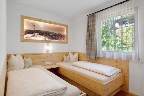a room with two beds and a window at Ferienhaus Anton in Gerlosberg