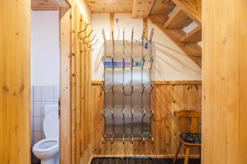 a bathroom with a toilet in a wooden house at Neuhaus Alm in Gerlosberg