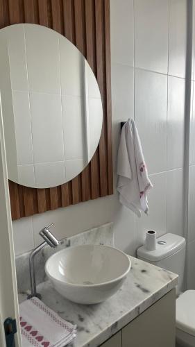 a white bathroom with a sink and a toilet at Gaudi in Santa Cruz do Sul