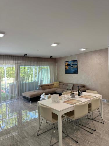 a living room with a table and a couch at BB Riviera Resort in Balatonboglár