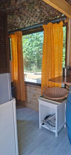 a small room with a table and a window at Logement insolite tente glamping in Parigné-lʼÉvêque