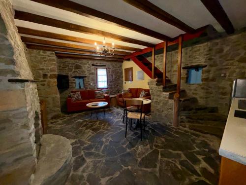 a living room with a couch and a table at Volissos Pirgos Village in Volissos