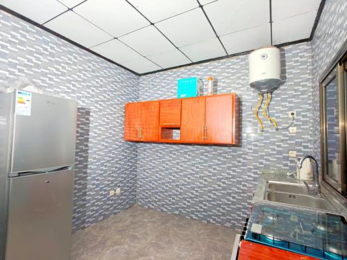 a kitchen with a refrigerator and a sink at Keitaya Dubreka Guinea in Conakry
