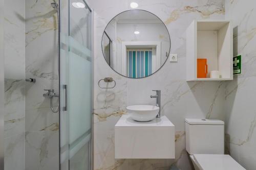 a bathroom with a sink and a mirror at Bocage Blue Heaven I, By Home Match in Setúbal