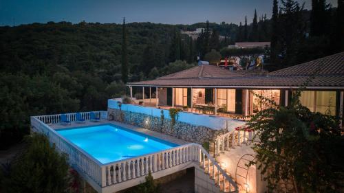 a house with a swimming pool and a building at Sunrise Stone Villa in Agios Nikolaos