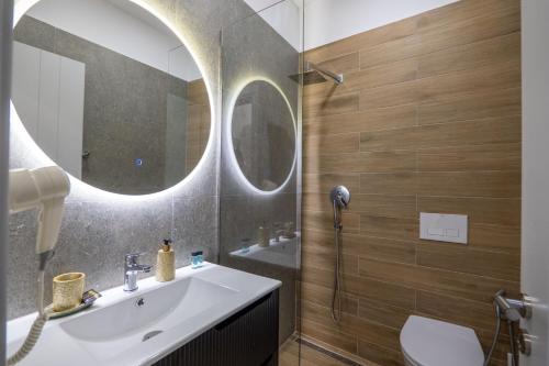 a bathroom with a sink and a mirror at SulMare Rooms in Sarandë