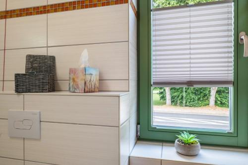 a window in a room with a window blinds at Pension Pusteblume in Meyenburg