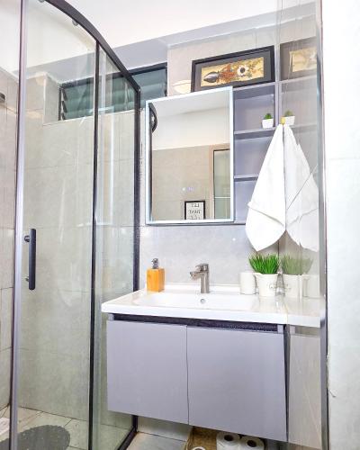 a bathroom with a sink and a shower at Skyline Westlands with Gym in Nairobi