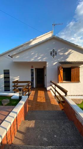 a white building with a porch and a door at La Casa de la Vall in Castellbell i Vilar