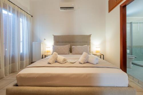 a bedroom with a large bed with two pillows at Keiz Retreat in Ermoupoli