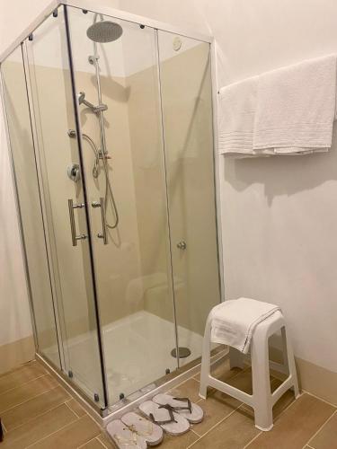 a shower with a glass enclosure and a stool at Hotel Imperiale in Fiuggi