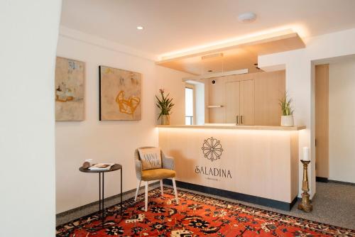 a waiting room with a counter and a chair at Aparthotel Saladina in Gaschurn