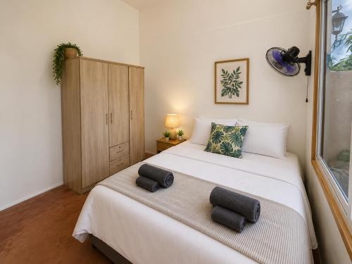 a bedroom with a bed with two pillows on it at Durano Seaside Retreat in Mercedes