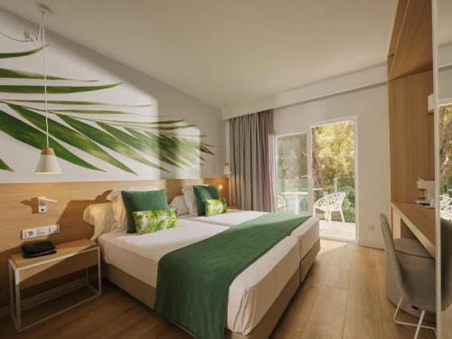 a hotel room with a bed and a window at BQ Paguera Boutique Hotel - Adults Only in Paguera